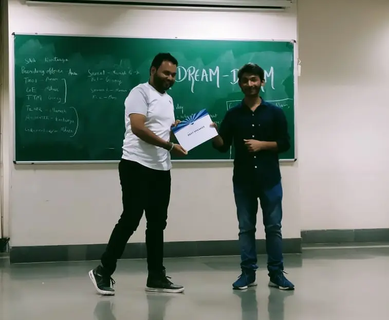 Toastmasters member receiving award, public speaking achievement.