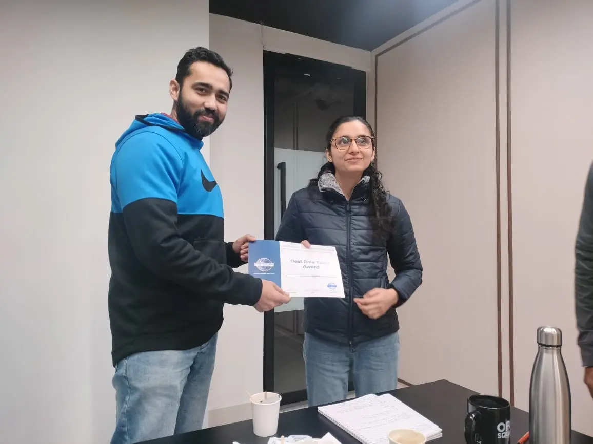 Toastmasters member receiving award, public speaking achievement.