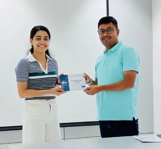 Toastmasters member receiving award, public speaking achievement.