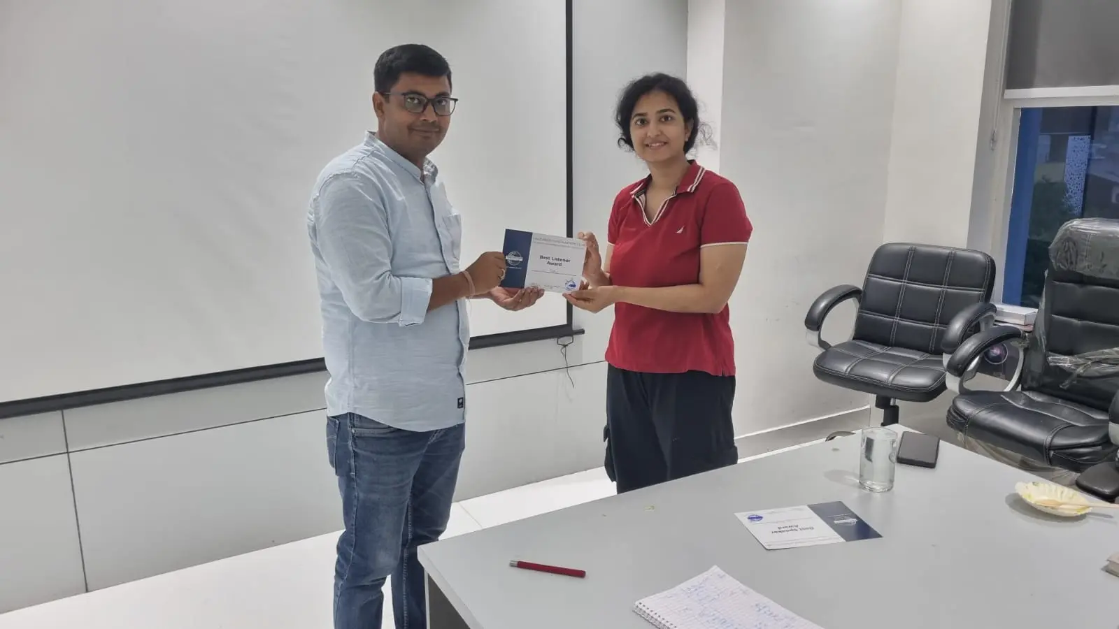 Toastmasters member receiving award, public speaking achievement.