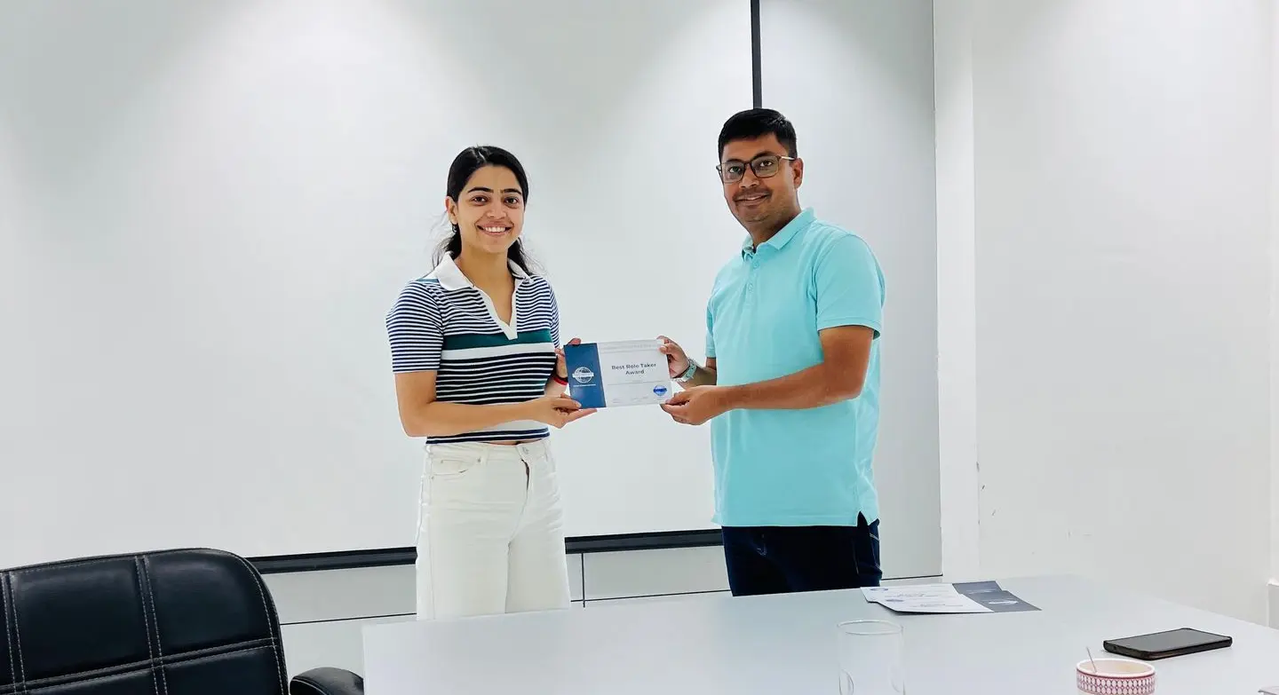 Toastmasters member receiving award, public speaking achievement.