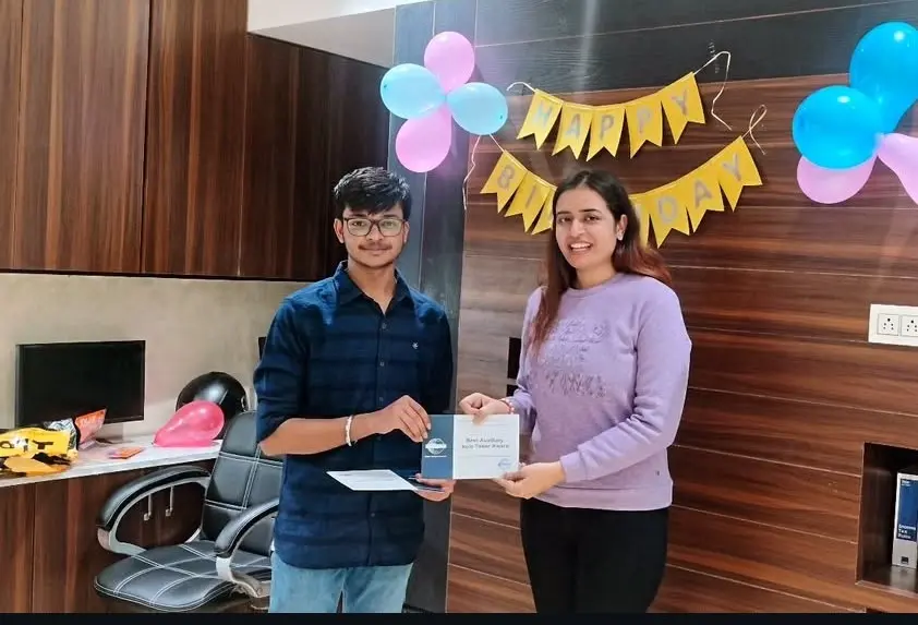 Toastmasters member receiving award, public speaking achievement.