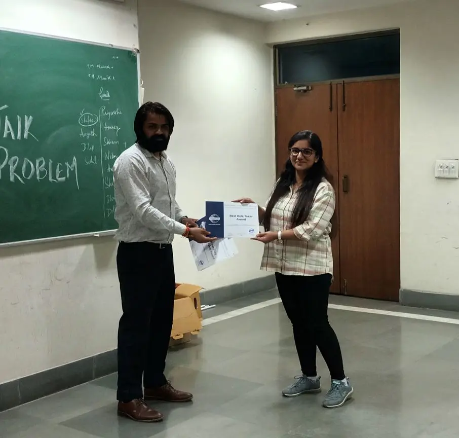 Toastmasters member receiving award, public speaking achievement.