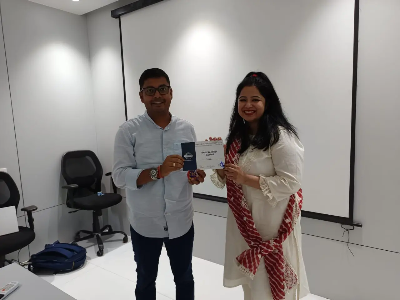 Toastmasters member receiving award, public speaking achievement.