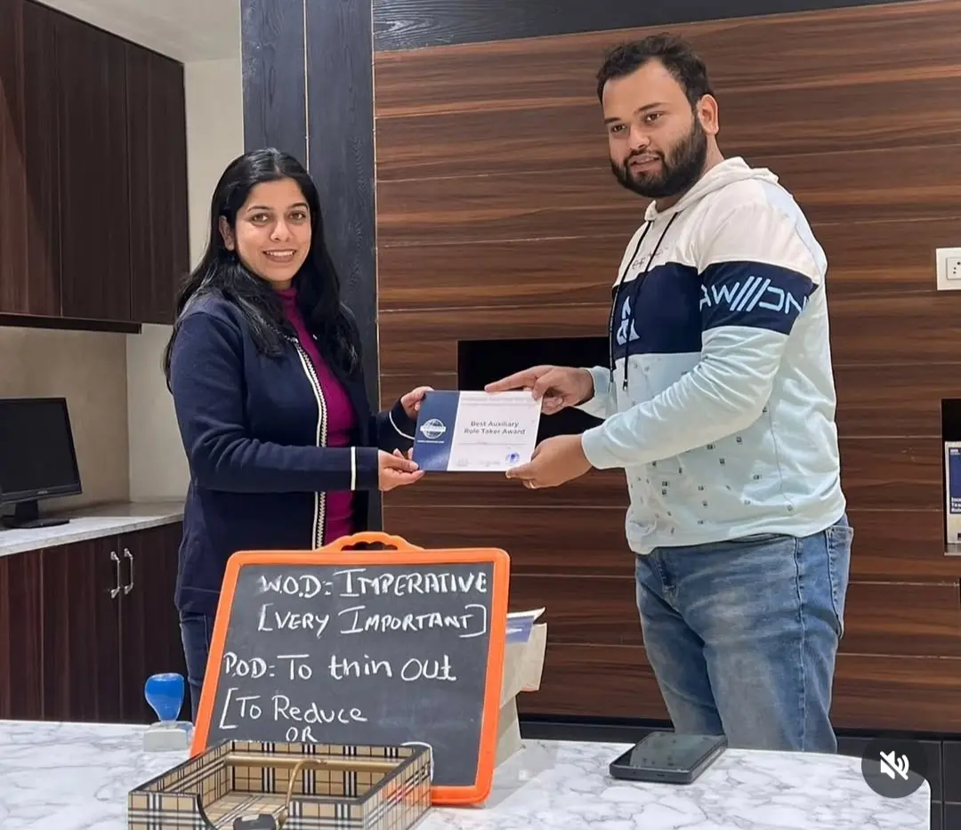 Toastmasters member receiving award, public speaking achievement.