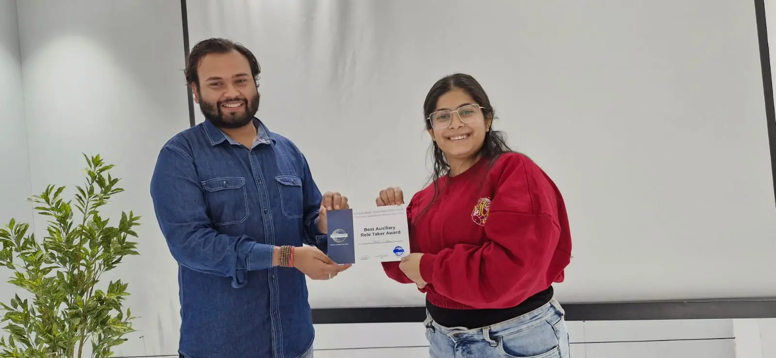 Toastmasters member receiving award, public speaking achievement.