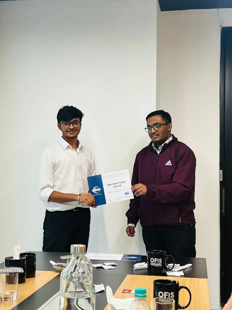 Toastmasters member receiving award, public speaking achievement.